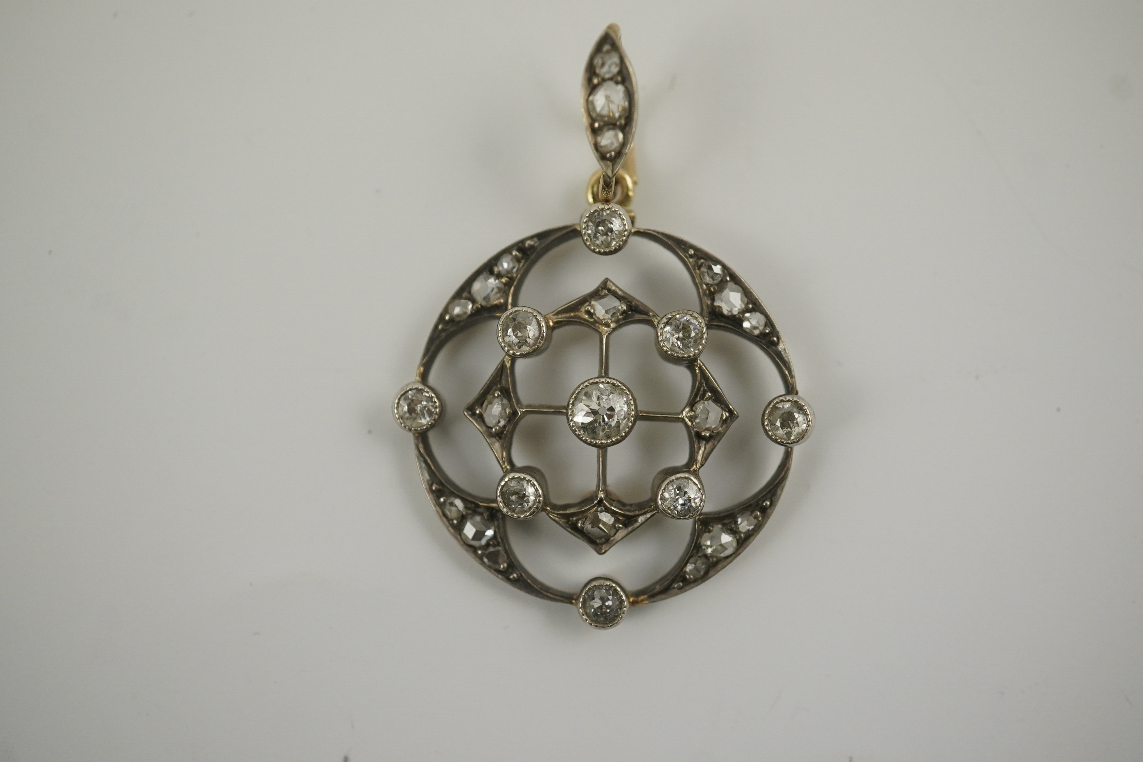 A cased Belle Epoque gold, rose and round cut diamond cluster set open work pendant/brooch